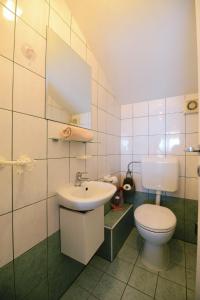 a bathroom with a toilet and a sink at Apartman Basioli1 in Zadar