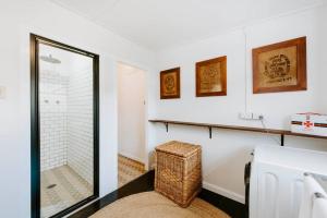 a bathroom with a walk in shower and a mirror at 'Mortimer Gardens' Country Charm in the Heart of Mudgee in Mudgee