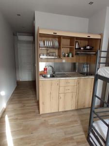 a kitchen with wooden cabinets and a sink at Horizon in Pefkohori