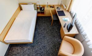 Postel nebo postele na pokoji v ubytování ABACUS Tierpark Hotel