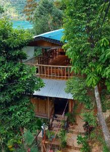 an overhead view of a house with a balcony at BaleCabugaoCottagesRental in El Nido