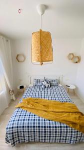 a bedroom with a bed with a blue and yellow blanket at Lily Beach - Apartment 408A in Sozopol