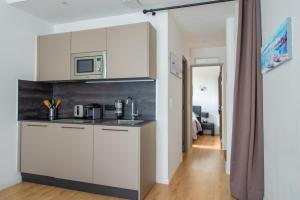 a kitchen with white cabinets and a microwave at JEAN MEDECIN - Modern and brand new 1Br flat in Nice