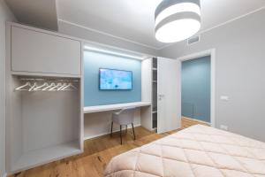 a bedroom with a bed and a desk and a tv at Le Dimore di Giò in Ortona +84 photos