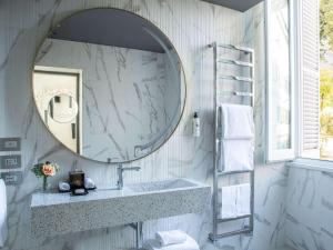 a bathroom with a sink and a mirror at Sofitel Roma Villa Borghese in Rome