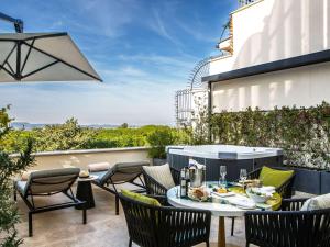 a patio with a table and chairs on a balcony at Sofitel Roma Villa Borghese in Rome