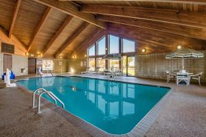 a large swimming pool in a building with a ceiling at AmericInn by Wyndham Windsor Ft. Collins in Fort Collins