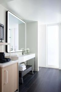 a bathroom with a sink and a large mirror at Hyatt Centric Congress Avenue Austin in Austin