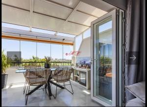 a dining room with a table and chairs on a balcony at Atico penthouse in Roquetas de Mar