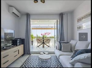 salon z kanapą i stołem w obiekcie Atico penthouse w mieście Roquetas de Mar