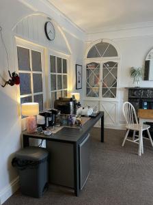 Habitación con escritorio y reloj en la pared. en The Dozy Deer, en Windermere