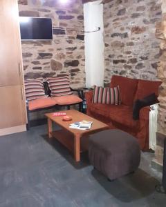 a living room with a couch and a table at O Busto Aldea Rural 