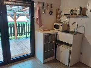 a kitchen with a sink and a microwave at Apartement Unten im Dorf 