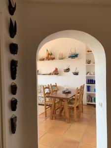 a dining room with a table and some boats on the wall at Costa Smeralda appartamento Pevero Golf in Arzachena