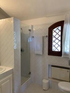 a bathroom with a shower and a toilet and a sink at Costa Smeralda appartamento Pevero Golf in Arzachena