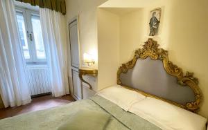 a bedroom with a bed with a mirror on the wall at Hotel San Michele in Cortona