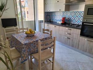 a kitchen with a table with a bowl of fruit on it at InCentro Palermo in Palermo