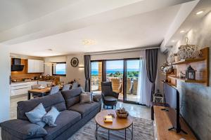 a living room with a couch and a table at Villa Kadena - Luxury Seaside Villa with Private Heated Pool in Selca