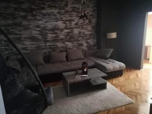 a living room with a couch and a coffee table at Fenix1 in Knjazevac.