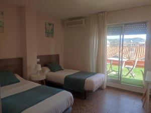 Postel nebo postele na pokoji v ubytování Hostal Garamar