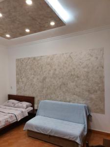 a room with two beds and a painting on the wall at Apartments Mira in Tivat