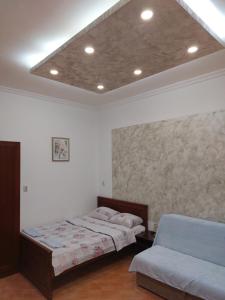 a bedroom with two beds and a ceiling at Apartments Mira in Tivat