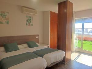 Postel nebo postele na pokoji v ubytování Hostal Garamar