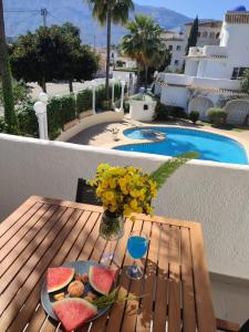a table with a plate of watermelons and a glass at Camino del Vasco in Denia