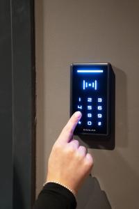 a person is holding a lighted clock on a wall at NUVA Apartments in Cologne