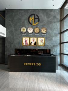a reception area with clocks on a wall at Modern Heights in Juffair