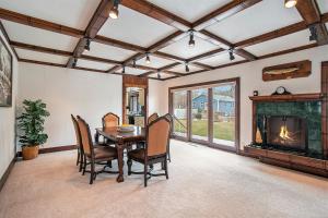 a dining room with a table and chairs and a fireplace at The Sugar Maple Home in South Haven