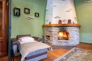 a bedroom with a stone fireplace and a bed at Old Town - Dunkri Apartment in Tallinn