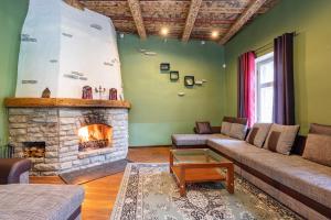 a living room with a couch and a fireplace at Old Town - Dunkri Apartment in Tallinn