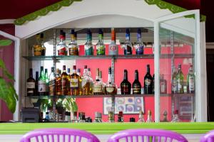 a bar with a bunch of bottles of alcohol at Bay Gardens Inn in Gros Islet