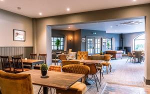 a restaurant with tables and chairs in a room at Filey Bay Beach House Step Free Accommodation The Bay Filey with ev car point in Filey