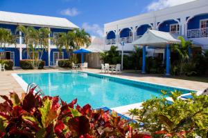 a swimming pool in front of a building at Bay Gardens Inn in Gros Islet