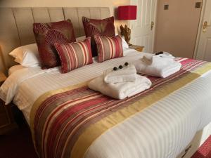 a large bed with towels on it with at Chester House Guest House in Chester