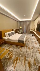 Postel nebo postele na pokoji v ubytování فندق رويال فيستا Royal Vista Hotel