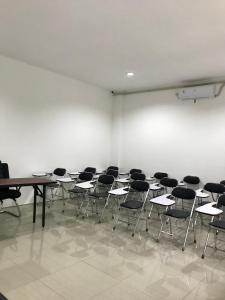 a room with a bunch of desks and chairs at Yayah Hostel in Bogor