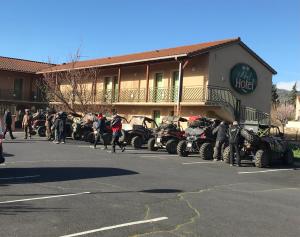 a group of people standing outside of a building with atvs at Abel Hôtel in Langeac