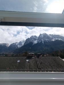 a view of a mountain range from the roof of a building at Gästehaus Ferienglück Grainau in Grainau