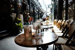 a wooden table on a street with tables and chairs at Studio for Professionals Trades Relocators in Cardiff