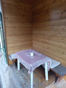 a sauna with a table and two benches in it at Gästehaus Ferienglück Grainau in Grainau