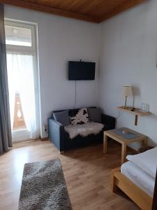 a living room with a couch and a table at Gästehaus Ferienglück Grainau in Grainau