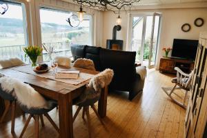 a living room with a table and a couch at WaldApart Willingen in Willingen