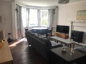 a living room with a couch and a table at Collingwood House Tynemouth in Tynemouth