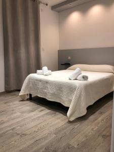 a bedroom with a bed with two towels on it at Hotel le Dauphin in Ajaccio
