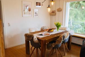 a dining room with a wooden table and chairs at WaldApart Willingen in Willingen