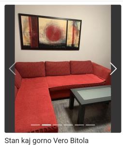 a red couch in a living room with a table at Apartment Sivakov in Bitola