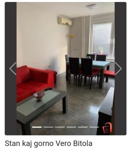 a living room with a red couch and a table at Apartment Sivakov in Bitola
